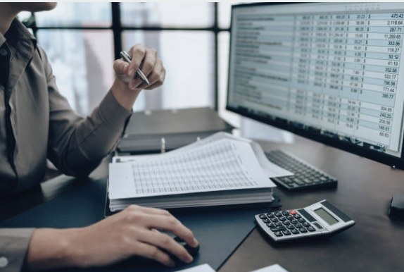 Financial figures in a spreadsheet open on a desktop monitor